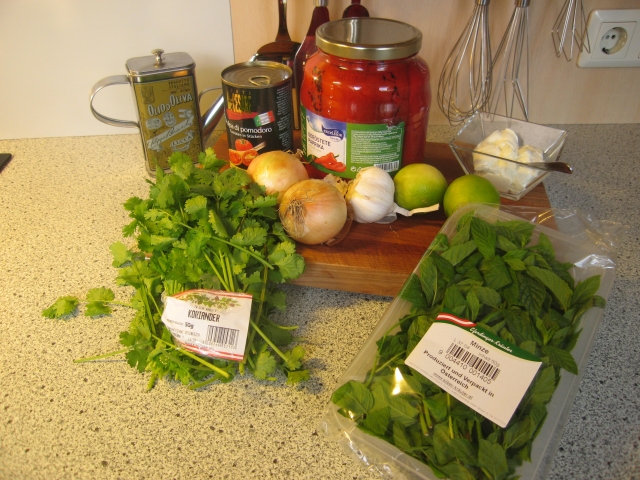 Zutaten für die Tomatensuppe: 1 Bund Koriander, Olivenöl, 2 gelbe Zwiebel, 800 g Tomatenstücke, 500 g gegrillte, geschälte Paprika aus dem Glas, 4 Knoblauchzehen, 2 Limetten, 250 g Joghurt, halber Bund Minze